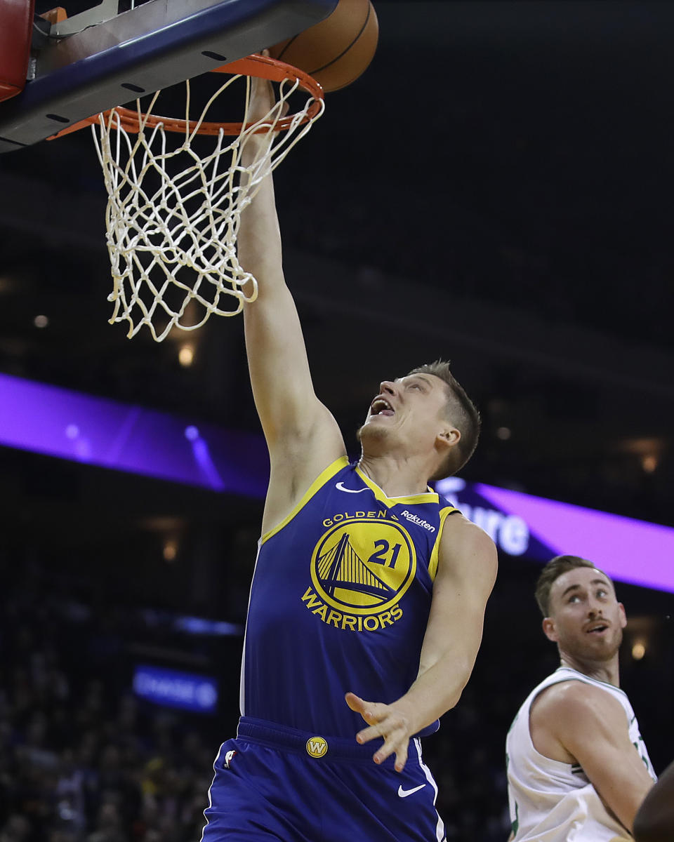 Golden State Warriors' Jonas Jerebko (21) lays up a shot against the Boston Celtics during the first half of an NBA basketball game Tuesday, March 5, 2019, in Oakland, Calif. (AP Photo/Ben Margot)