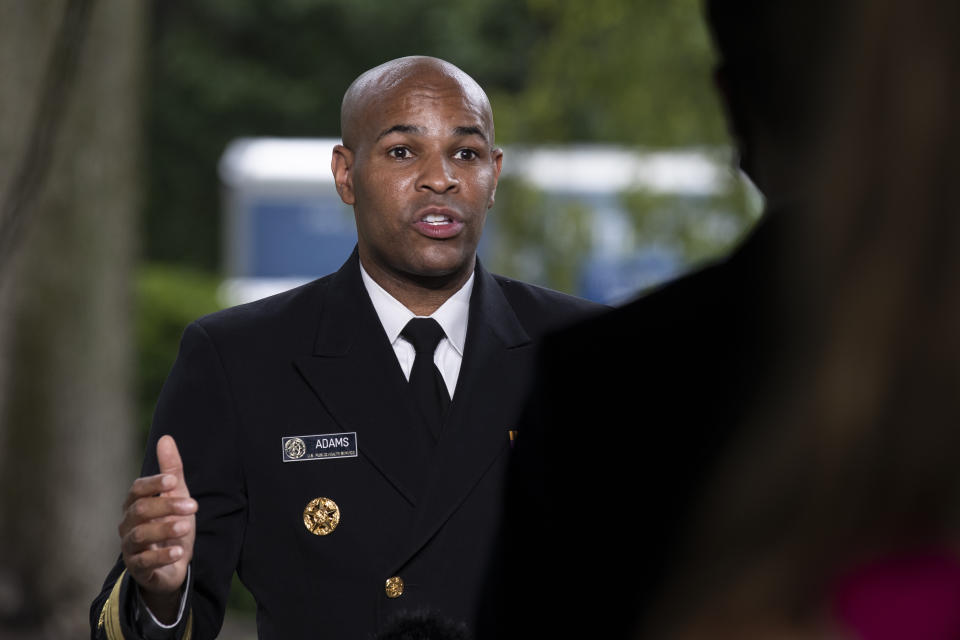 U.S. Surgeon General Jerome Adams does a television interview on the North Lawn of the White House, Tuesday, July 7, 2020, in Washington. (AP Photo/Alex Brandon)