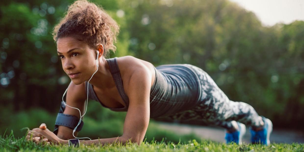 woman performing plank in park