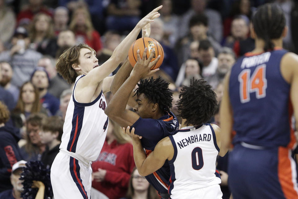 Gonzaga guards Dusty Stromer (4) and Ryan Nembhard (0) double-team Pepperdine guard Michael Ajayi during the first half of an NCAA college basketball game Thursday, Jan. 4, 2024, in Spokane, Wash. (AP Photo/Young Kwak)