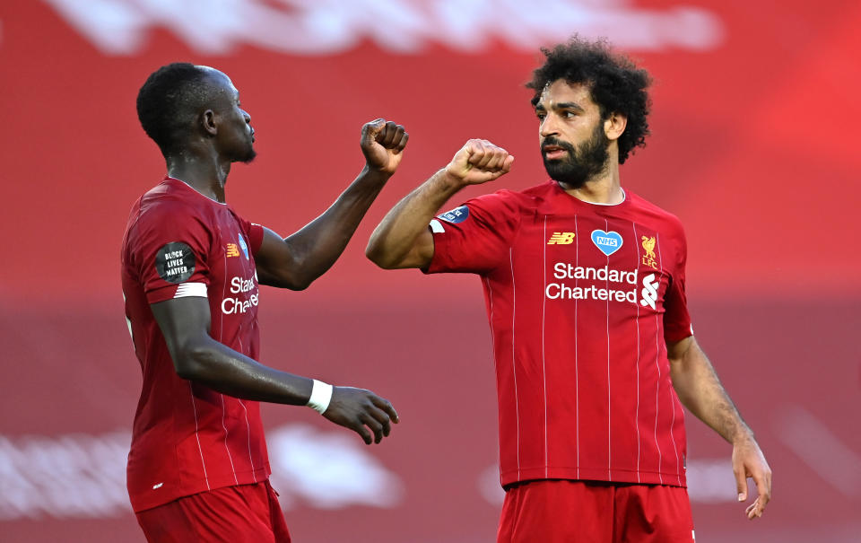 LIVERPOOL, ENGLAND - JUNE 24: Mohamed Salah of Liverpool celebrates after he scores his sides second goal with Sadio Mane of Liverpool during the Premier League match between Liverpool FC and Crystal Palace at Anfield on June 24, 2020 in Liverpool, England. (Photo by Paul Ellis/Pool via Getty Images)