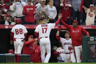 Los Angeles Angels' Shohei Ohtani (17) celebrates his home run against the Chicago Cubs with coaches and teammates during the fourth inning of a baseball game Tuesday, June 6, 2023, in Anaheim, Calif. (AP Photo/Jae C. Hong)