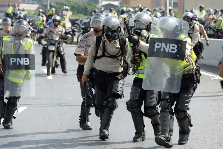 Police confront Venezuelan opposition activists demonstrating against President Nicolas Maduro, in Caracas, on April 24, 2017