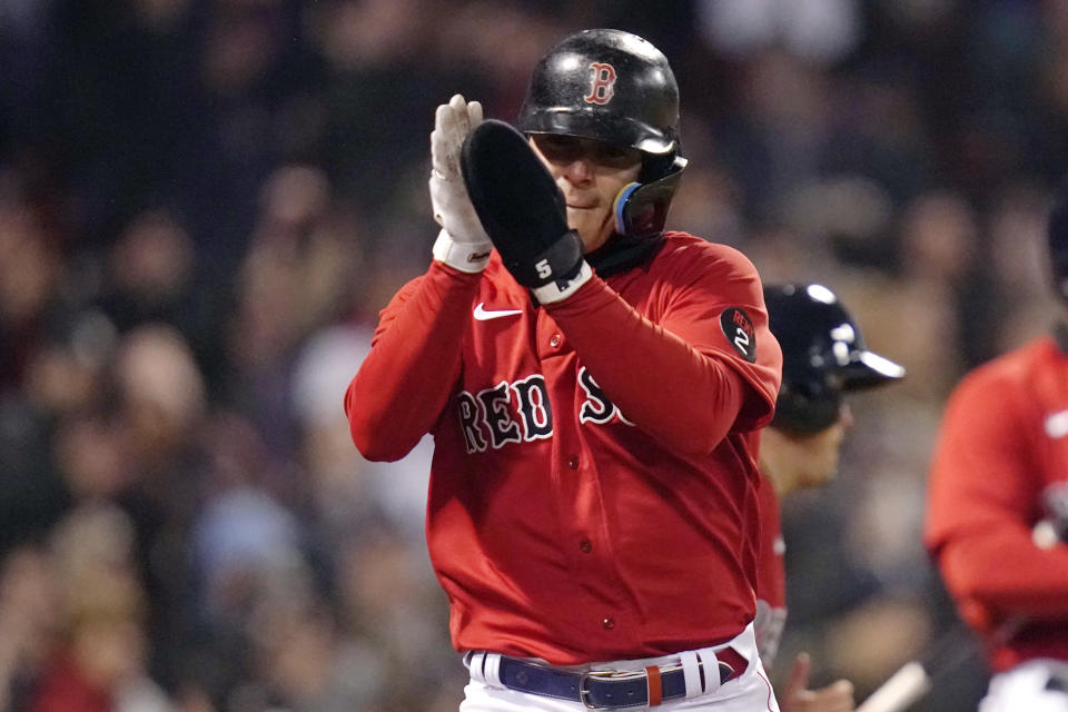 Boston Red Sox's Enrique Hernandez applauds after scoring on an RBI double by Trevor Story during the third inning of a baseball game against the Toronto Blue Jays, Tuesday, April 19, 2022, at Fenway Park in Boston. (AP Photo/Charles Krupa)