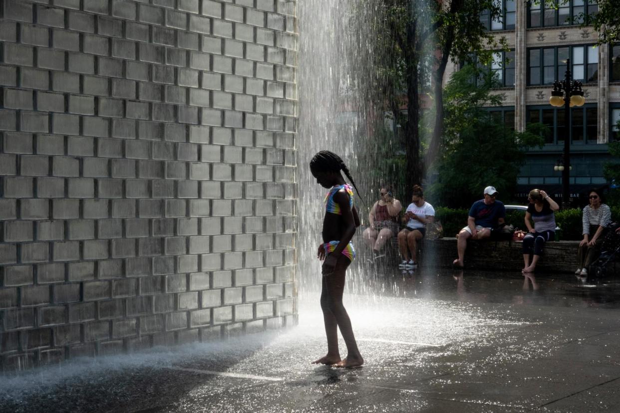 <span>A child cools off in Chicago as temperatures reached a record high of 97F on 17 June 2024.</span><span>Photograph: Scott Olson/Getty Images</span>