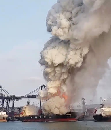 Smoke and debris rises from a KMTC cargo ship after it caught on fire at the Laem Chabang port, Chonburi province, Thailand May 25, 2019 in this still image take from social media video. Mbah Ambyah via REUTERS