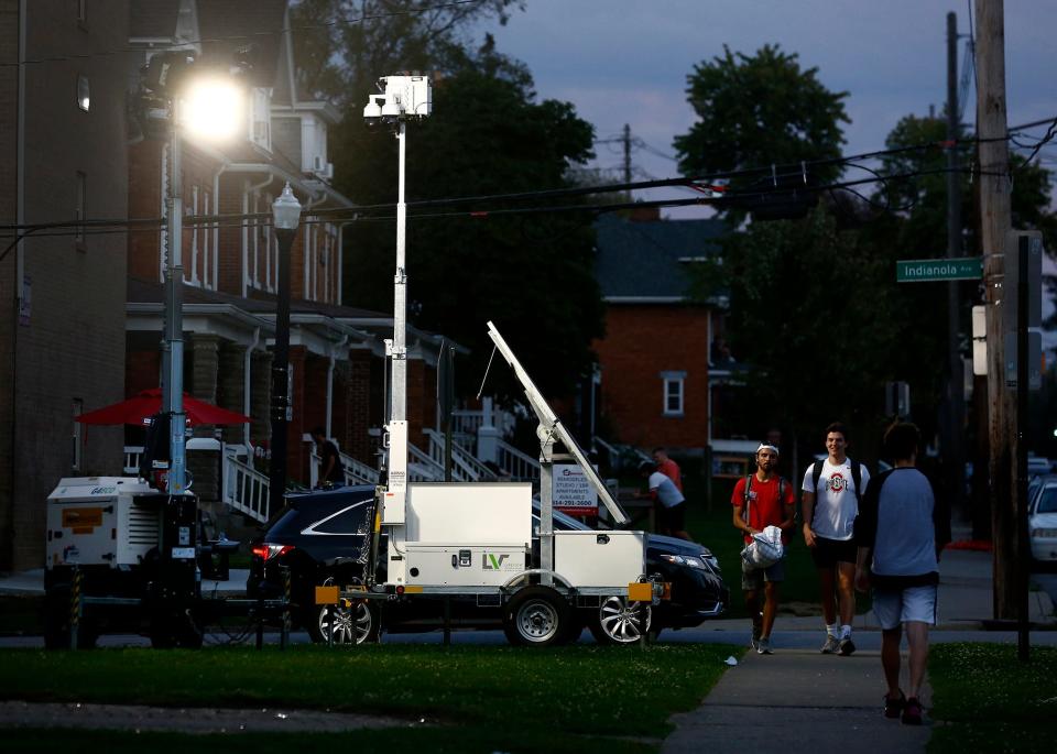 Ohio State has invested in mobile lighting units  to light up high traffic walkways at night near the campus.. Mobile lights brighten up an area along Indianola Ave. on Friday, October 8, 2021. To the right of the lights is a moble camera unit.