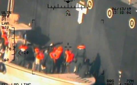 This photo shows what the Navy says are members of the Islamic Revolutionary Guard Corps Navy removing an unexploded limpet mine from the M/T Kokuka Courageous - Credit: AP