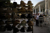 Tourists sit at a tavern in the main town of the Aegean Sea island of Rhodes, southeastern Greece, Tuesday, May 10, 2022. Russia's war in Ukraine has accelerated inflation across Europe, with prices for energy, materials and food surging at rates not seen for decades. Inflation is expected to hit nearly 7% this year in the 27-nation EU and is contributing to slowing growth forecasts. (AP Photo/Thanassis Stavrakis)