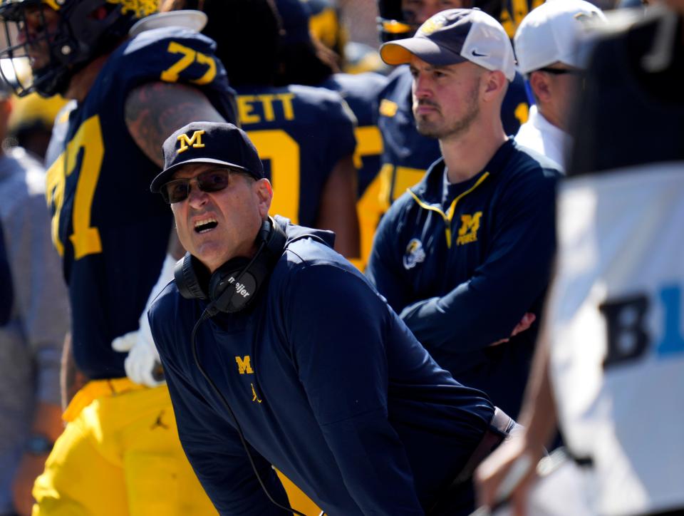 Michigan assistant Connor Stalions, right, looks on during a game in September. Stalions was suspended by the university and is at the center of a sign-stealing scheme that is being investigated by the NCAA.