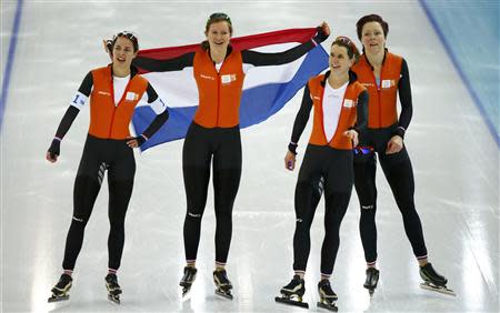Marrit Leenstra (L-R), Lotte van Beek, Ireen Wust and Jorien ter Mors of the Netherlands celebrate winning in the women's speed skating team pursuit Gold-medal race at the Adler Arena in the Sochi 2014 Winter Olympic Games February 22, 2014. REUTERS/Marko Djurica