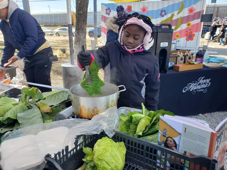 Maya Lynch, 9, of Mansfield, Tex., blanches freshly picked cabbage in preparation for chef Amber Williams' cabbage wraps at Joppy Momma's Farm in Joppa, south of Dallas, on January 20, 2024. The fourth-grader was visiting the community farm and garden to learn about nutritional, farm-to-table eating as well as about Joppa's status as a food desert. Williams, who grew up in a food desert and once relied on food pantries, recently published "Surviving the Food Desert," a cookbook designed for families facing such situations.