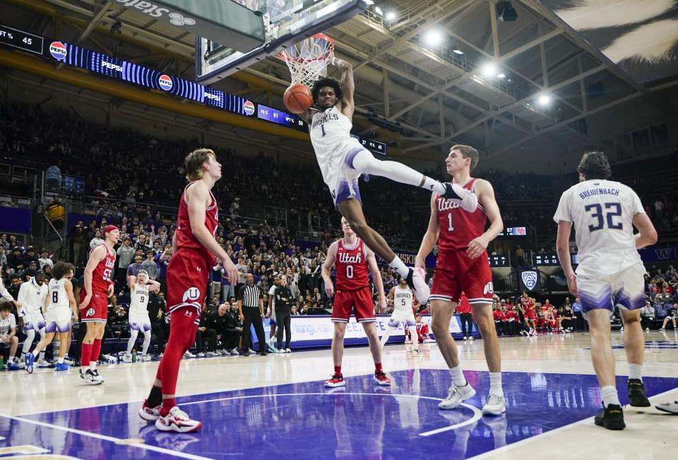 Washington forward Keion Brooks Jr. (1) dunks as Utah forward Jake Wahlin, left, guard Hunter Erickson (0) and forward Ben Carlson (1) watch during the second half of an NCAA college basketball game Saturday, Jan. 27, 2024, in Seattle. Washington won 98-73. | Lindsey Wasson, Associated Press