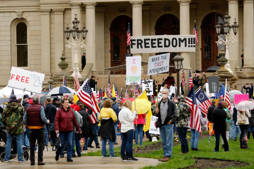 Demonstrators take part in an "American Patriot Rally," organized on April 30, 2020, by Michigan United for Liberty on the steps of the Michigan State Capitol in Lansing, demanding the reopening of businesses. - Michigan's stay-at-home order declared by Democratic Governor Gretchen Whitmer is set to expire after May 15. (Photo by JEFF KOWALSKY / AFP) (Photo by JEFF KOWALSKY/AFP via Getty Images)