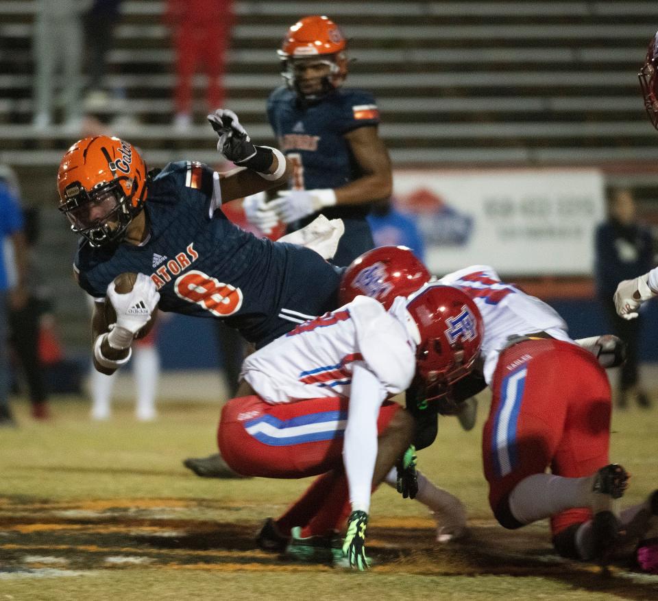 Escambia's Tyqan Stabler (No. 8) picks up a few extra yards against the pine Forest defense during Friday Night's District 1-3S matchup. 