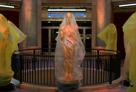 Oscar statues sit covered in plastic at the entrance to the Dolby Theatre as preparations continue for the 89th Academy Awards in Hollywood, California, U.S. February 25, 2017. REUTERS/Mike Blake