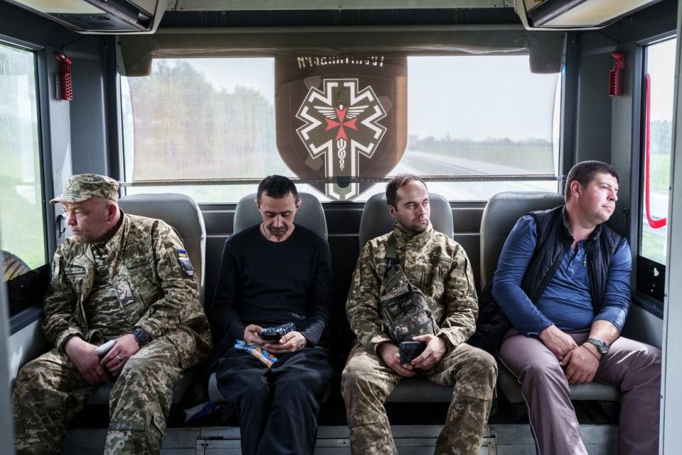 Wounded Ukrainian servicemen rest inside the Hospitallers evacuation bus driving from the front line in Donetsk Oblast to Dnipro on April 25, 2024. (Serhii Korovayny/The Kyiv Independent)