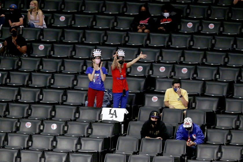 LOS ANGELES, CA - APRIL 18: LA Clippers' fans of LA Clippers guard Reggie Jackson (1) in designated seats in a game against the Minnesota Timberwolves at the Staples Center on Sunday, April 18, 2021 in Los Angeles, CA. (Gary Coronado / Los Angeles Times)