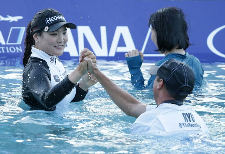 Ryu So-Yeon of South Korea celebrates with her caddie Tom Watson after defeating Lexi Thompson in a playoff during the final round of the ANA Inspiration, at Mission Hills Country Club in Rancho Mirage, California, on April 2, 2017