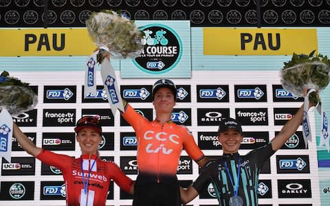 The Netherlands' Marianne Vos (C) celebrates her victory past second-placed Canada's Leah Kirchmann (L) and third-placed Denmark's Cecilie Ludwig on the podium of "La Course by Le Tour", as part of the 106th edition of the Tour de France cycling race, in Pau, on July 19, 2019 - Credit: AFP