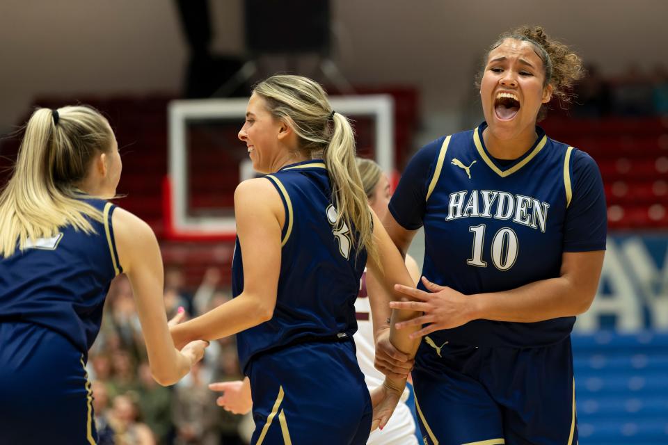 Hayden's Amelia Ramsey (10) celebrates after Avery Grunert (3) scores three points during State Basketball March. 8, 2024 at Hutchinson Sports Arena.