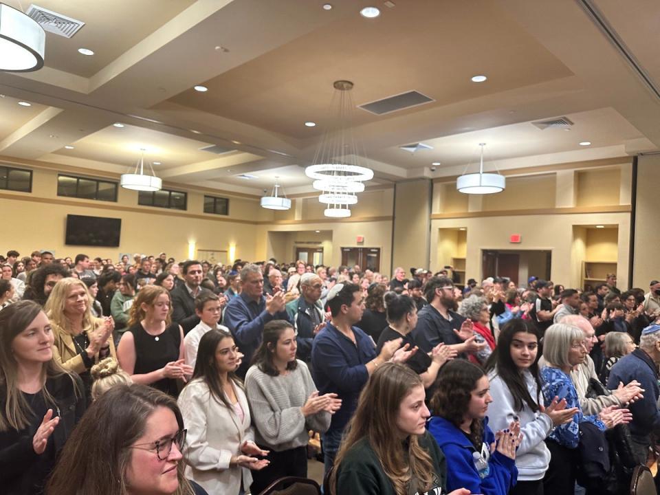 The crowd at the Chabad UF Jewish Student Center on Monday night applauds following a presentation by Holocaust survivor Irene Zisblatt.