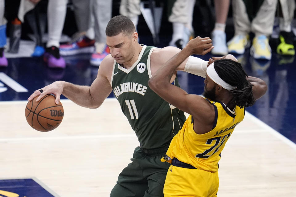 Milwaukee Bucks center Brook Lopez (11) drives around Indiana Pacers forward Isaiah Jackson (22) during the second half in Game 6 in an NBA basketball first-round playoff series, Thursday, May 2, 2024, in Indianapolis. (AP Photo/Michael Conroy)