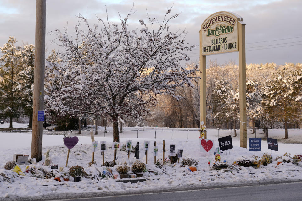 Snow accumulates outside a restaurant at a makeshift memorial for the victims of last month's mass shooting in Lewiston, Maine, Tuesday, Dec. 5, 2023. With winter approaching, officials began removing memorials to the 18 people killed. (AP Photo/Robert F. Bukaty)