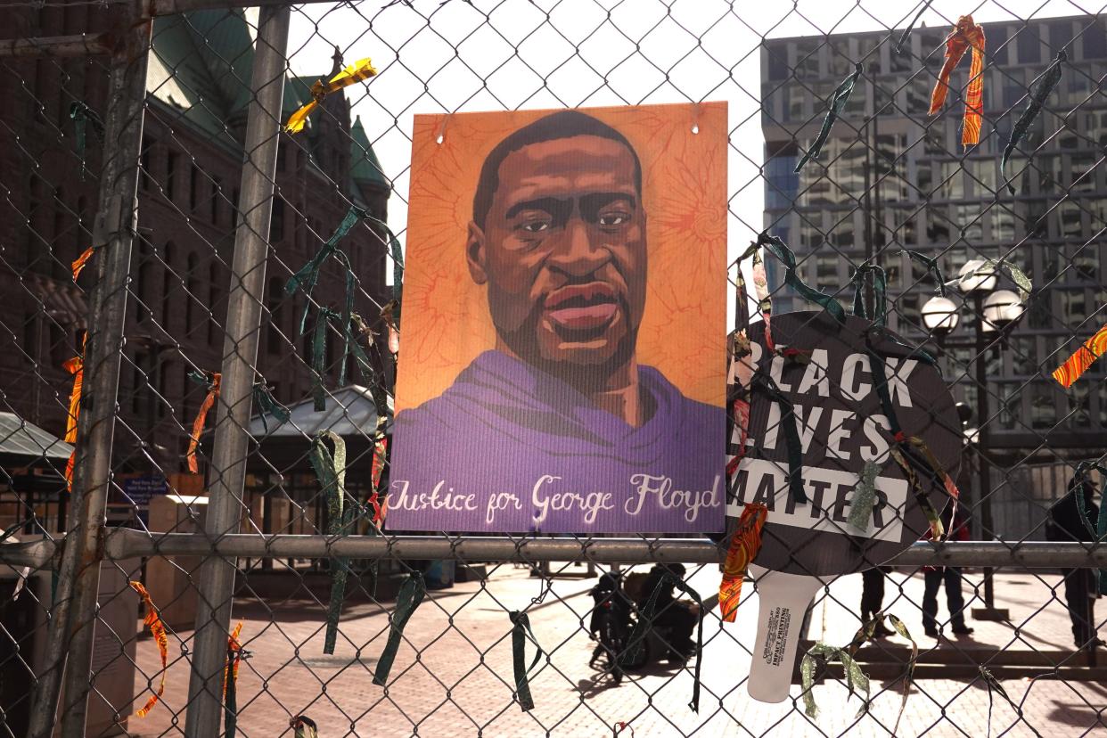 <p>A picture of George Floyd hangs on a fence barrier that surrounds the Hennepin County Government Center as the trial of former Minneapolis police officer Derek Chauvin continues on March 30, 2021 in Minneapolis, Minnesota. Chauvin is accused of murder in the death of George Floyd.   </p> ((Photo by Scott Olson/Getty Images))