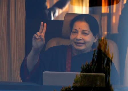 FILE PHOTO - J. Jayalalithaa, chief minister of Tamil Nadu and chief of Anna Dravida Munetra Khazhgam (AIADMK), gestures from inside a vehicle after addressing her party supporters during an election campaign rally in Chennai April 19, 2014. REUTERS/Babu/File Photo