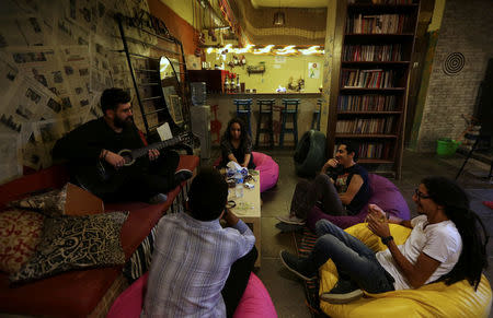 Visitors play music and talk together in the bookshop where the new "scream room" is found, in Cairo, Egypt October 23, 2016. REUTERS/Mohamed Abd El Ghany