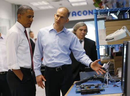 President Obama listens to engineer Rod Washington as he tours Vacon, a company that manufactures AC drives, during a visit to Raleigh, North Carolina, January 15, 2014. REUTERS/Kevin Lamarque