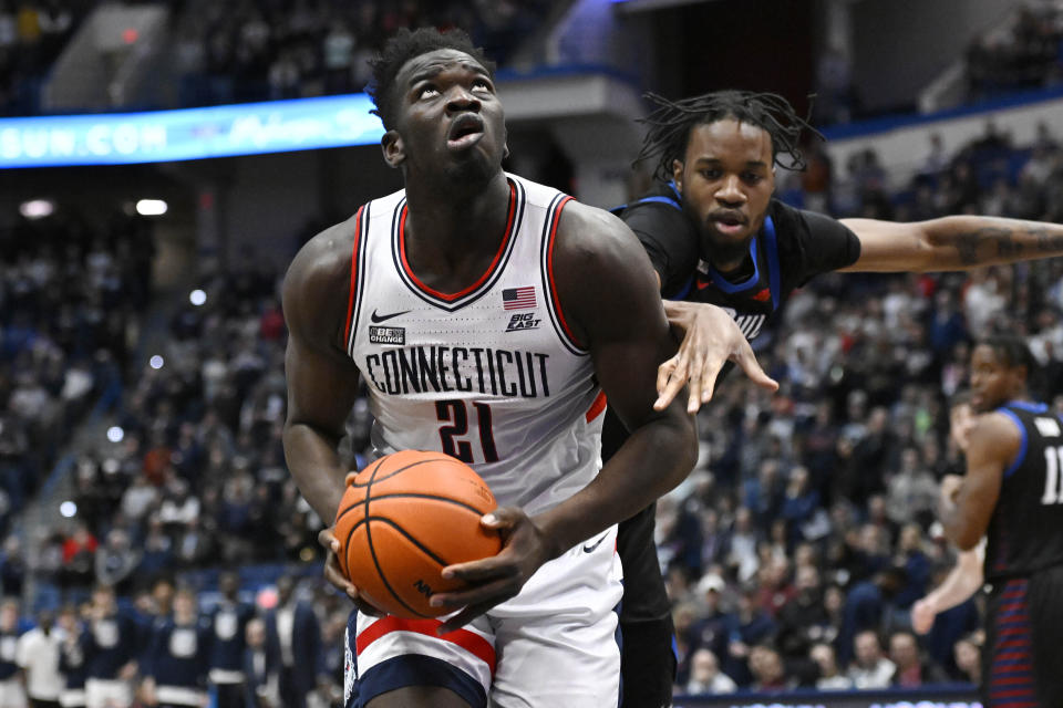 UConn's Adama Sanogo (21) looks to shoot as DePaul's Nick Ongenda defends in the first half of an NCAA college basketball game, Wednesday, March 1, 2023, in Hartford, Conn. (AP Photo/Jessica Hill)