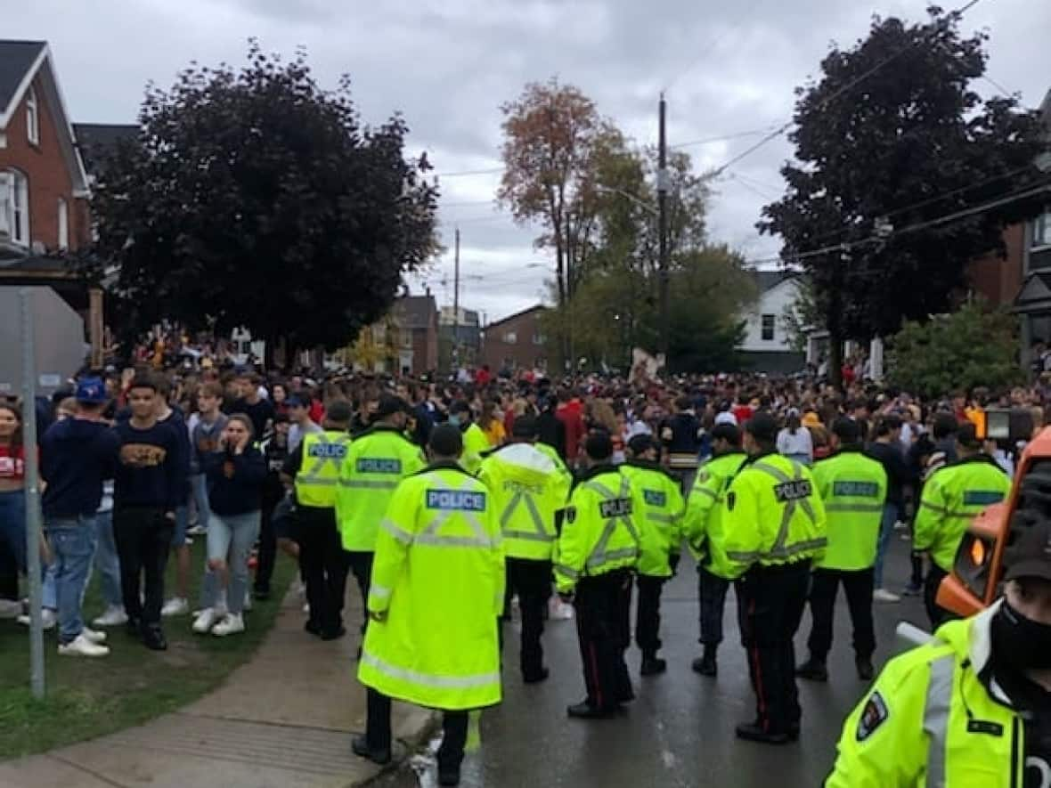 Police in Kingston, Ont., tweeted this photo of a party on Aberdeen Street in the city's university district on Oct. 16. Police and bylaw officers handed out more than 120 charges and fines after a similar gathering this past weekend. (@KingstonPolice/Twitter - image credit)