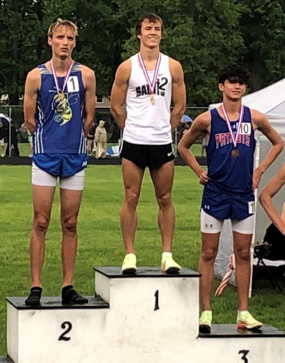 TCC's Jackson Triplett stands atop  the podium after winning the Division III regional title in the boys 1600.