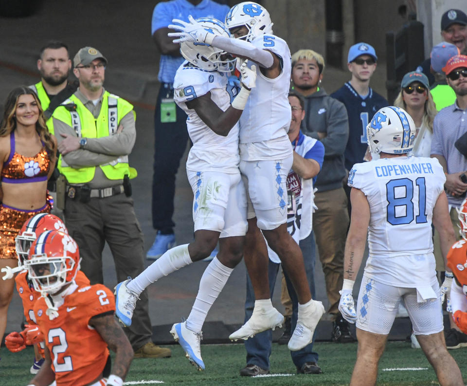 Nov 18, 2023; Clemson, South Carolina, USA; North Carolina Tar Heels wide receiver J.J. Jones (5) celebrates with wide receiver Devontez Walker (9) after making a touchdown catch against Clemson Tigers during the first quarter at Memorial Stadium. Mandatory Credit: Ken Ruinard-USA TODAY Sports