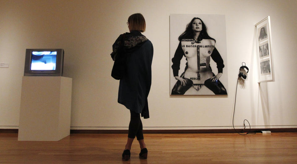 In this photo taken Tuesday, Oct. 9, 2012, a visitor looks at work brought from the Pompidou Center in Paris as part of one of two new exhibits featuring art exclusively by women at the Seattle Art Museum, in Seattle. Included in the exhibition is the only U.S. stop for an exhibit from the Pompidou, home of the modern art museum there, of painting, sculpture, drawing, photography and video. The exhibit runs through Jan. 13, 2013. (AP Photo/Elaine Thompson)