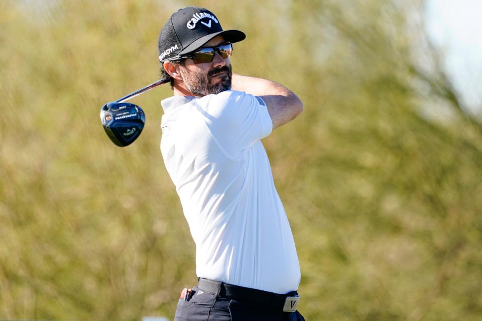 Adam Hadwin watches his tee shot on the ninth hole during the first round of the Phoenix Open golf tournament Thursday, Feb. 9, 2023, in Scottsdale, Ariz. (AP Photo/Darryl Webb)
