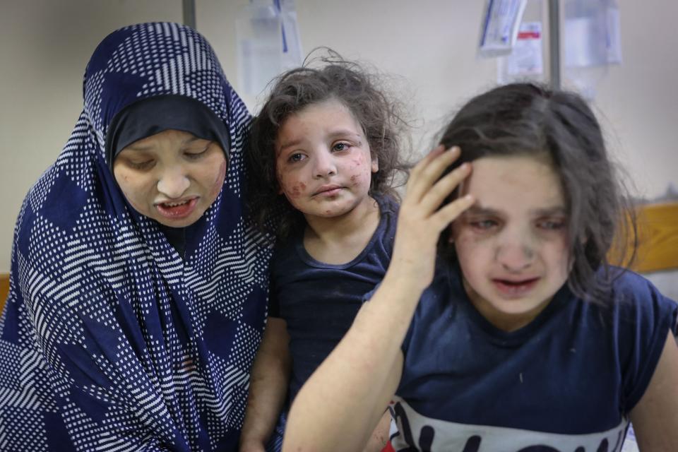 A Palestinian family arrives at Shifa hospital after intensive bombardments on GazaAFP via Getty Images