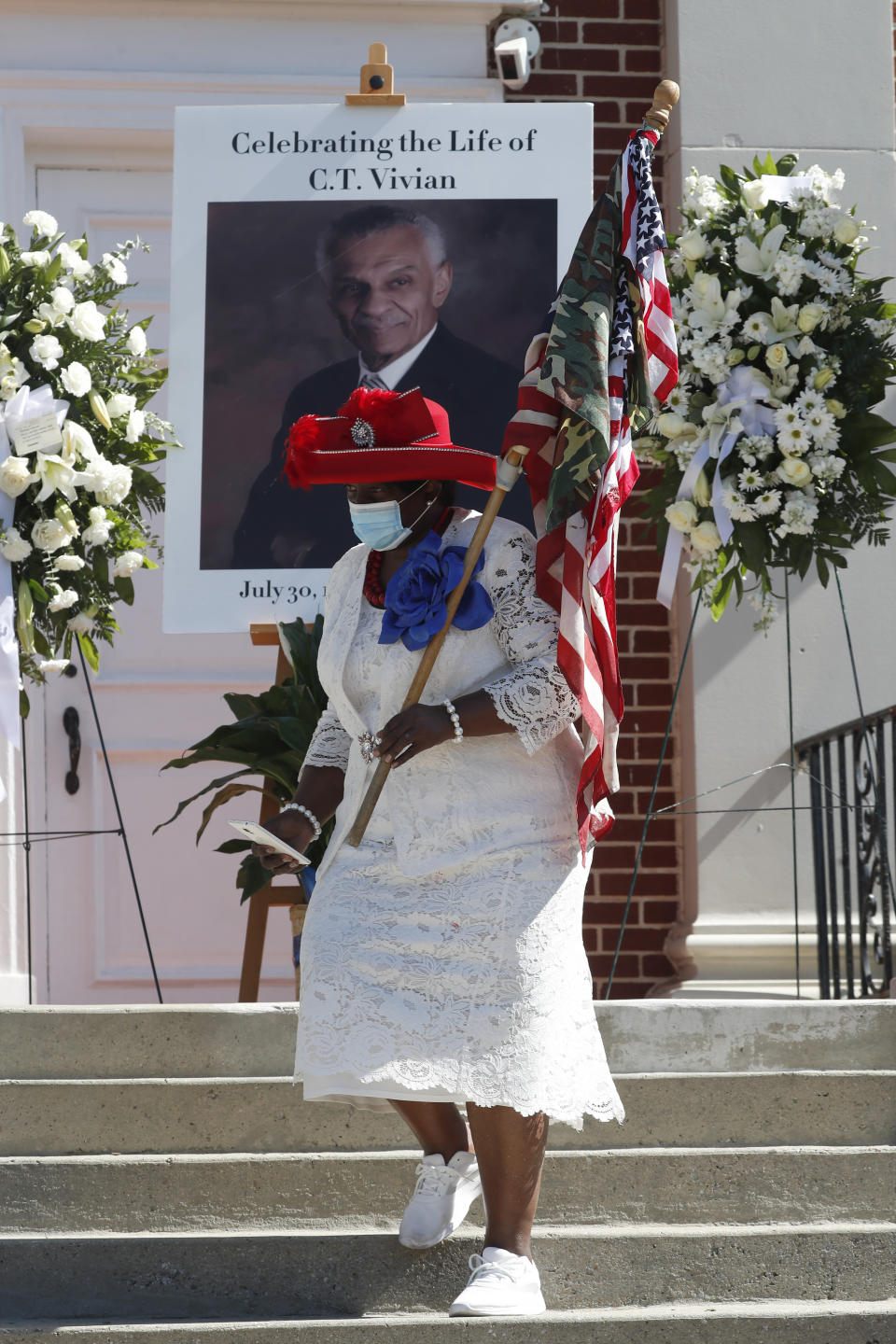 A woman stands outside a funeral service for Rev. C.T. Vivian Thursday, July 23, 2020, in Atlanta. Vivian, an early and key adviser to the Rev. Martin Luther King Jr., died Friday at the age of 95. (AP Photo/John Bazemore)