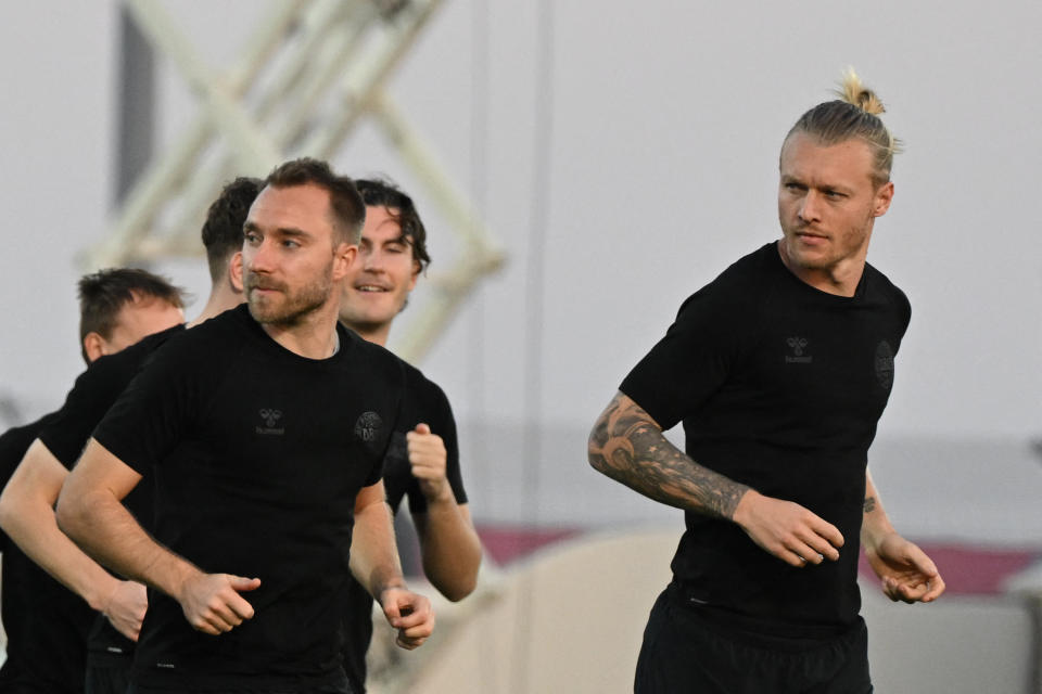 Denmark's midfielder Christian Eriksen (L) and Denmark's defender Simon Kjaer  take part in a training session at Al Sailiya SC in Doha on November 25, 2022, on the eve of the Qatar 2022 World Cup football tournament Group D match between France and Denmark. (Photo by NATALIA KOLESNIKOVA / AFP) (Photo by NATALIA KOLESNIKOVA/AFP via Getty Images)