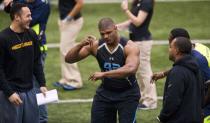 Missouri defensive lineman Michael Sam, center, dances as he jokes with teammates during pro day for NFL football representatives Thursday, March 20, 2014, in Columbia, Mo. (AP Photo/L.G. Patterson)