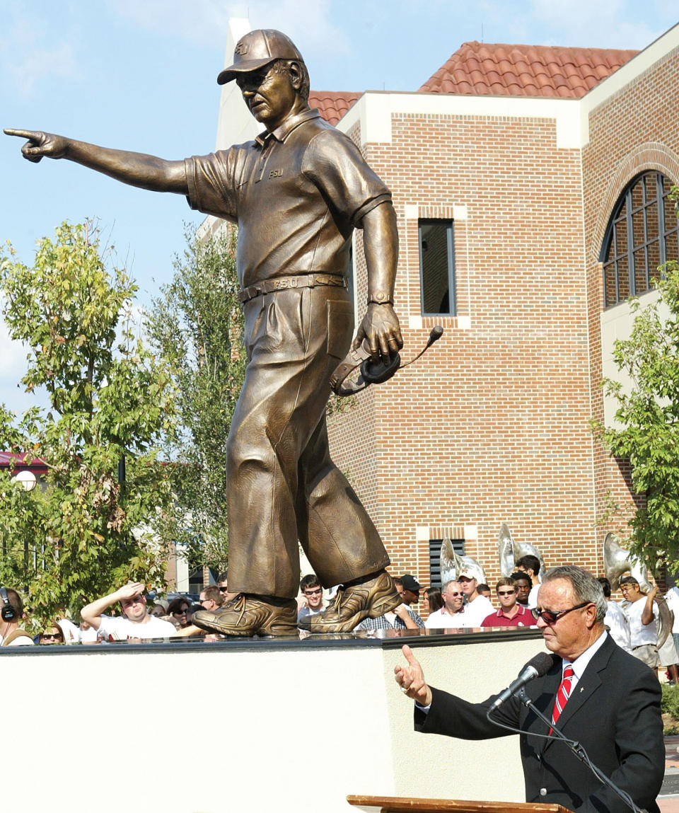 FILE - In this Sept. 24, 2004, file photo, Florida State head coach Bobby Bowden, lower right, speaks to the crowd following the unveiling of a statue in his likeness in front of the Florida State athletic department in Tallahassee, Fla. Bowden, the folksy Hall of Fame coach who built Florida State into an unprecedented college football dynasty, has died. He was 91. Bobby's son, Terry, confirmed to The Associated Press that his father died at home in Tallahassee, Fla., surrounded by family early Sunday, Aug. 8, 2021. (AP Photo/Phil Coale, File)