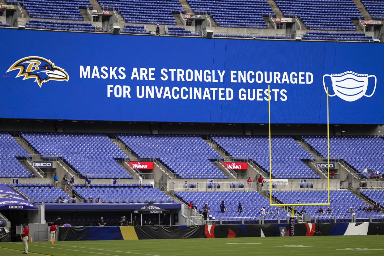 Ravens sign asking unvaccinated fans to wear masks. 