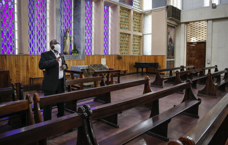 A lone worshipper attends a service without a congregation but which was broadcast on television, at the Cathedral Basilica of the Holy Family in Nairobi, Kenya, on Easter Sunday, April 12, 2020. The new coronavirus causes mild or moderate symptoms for most people, but for some, especially older adults and people with existing health problems, it can cause more severe illness or death. (AP Photo/Brian Inganga)