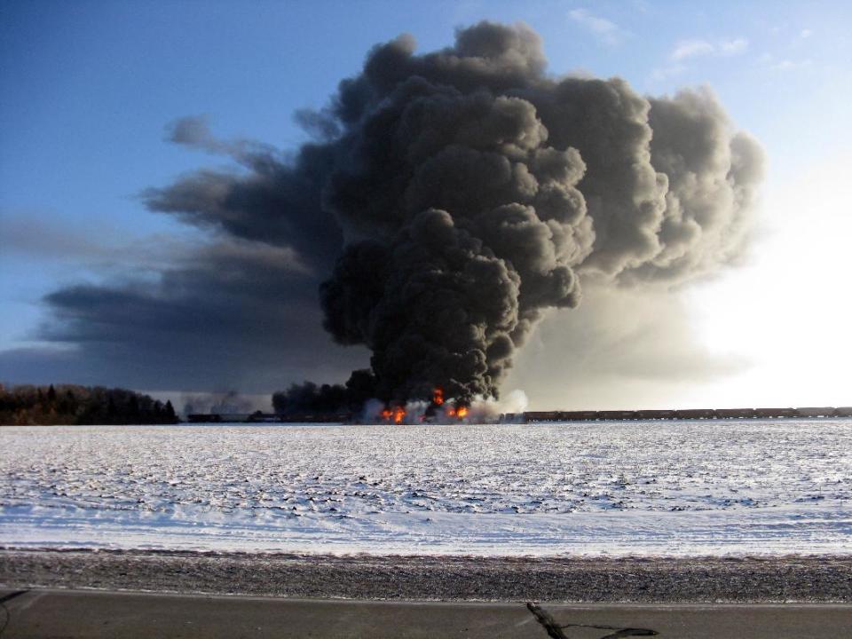 This photo provided by Cass County Commissioner Ken Pawluk shows a train derailment and fire west of Casselton, N.D., Monday, Dec. 30, 2013. No one has been reported hurt in the derailment or fire. By late Monday afternoon, the smoke plume was diminishing and was staying mostly away from town. (AP Photo/Ken Pawluk)
