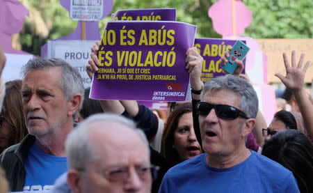 People shout slogans during a protest outside the City of Justice, after a Spanish court on Thursday sentenced five men accused of the group rape of an 18-year-old woman at the 2016 San Fermin bull-running festival each to nine years in prison for the lesser charge of sexual abuse, in Valencia, Spain April 27, 2018. The sign read: "It is not abuse, it is rape" and "Sister, I do believe you; there is enough of patriarchal justice". REUTERS/Heino Kalis