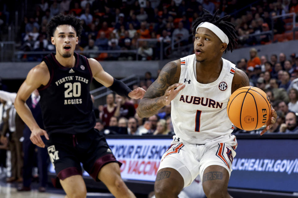 Auburn guard Wendell Green Jr. (1) dribbles the ball as Texas A&M guard Andre Gordon (20) defends during the second half of an NCAA college basketball game Wednesday, Jan. 25, 2023, in Auburn, Ala.. (AP Photo/Butch Dill)