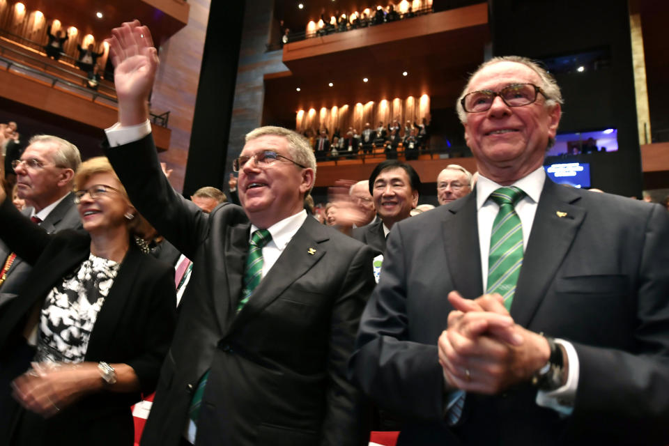 FILE - Then President of the Rio 2016 Olympic Organizing Committee Carlos Arthur Nuzman, right, and International Olympic Committee President Thomas Bach, second right, applaud during the opening ceremony of the 129th International Olympic Committee session, in Rio de Janeiro on August 1, 2016, ahead of the Rio 2016 Olympic Games. Nuzman, the head of the Brazilian Olympic Committee for more than two decades, was sentenced to 30 years and 11 months in jail for allegedly buying votes for Rio de Janeiro to host the 2016 Olympics. The ruling by Judge Marcelo Bretas became public Thursday, Nov. 25, 2021. (Fabrice Coffrini/Pool Photo via AP, File)