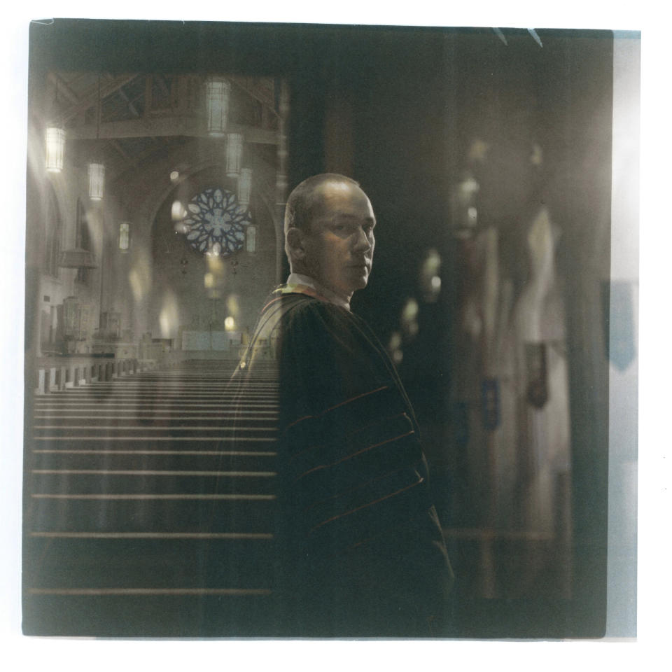 In this double exposure darkroom print made from two film negatives, a portrait of Rev. Stephen Cady is layered with a photo of the sanctuary of Asbury First United Methodist Church where he preaches, Monday, Aug. 21, 2023, in Rochester, N.Y. His church, in a city where 63 people were killed in shootings last year, presides over a leafy neighborhood of carefully kept homes largely bypassed by the violence. But for a congregation unsettled by the increase in mass shootings and the deaths across town that garner far less attention, the way forward would only be darkened by adding even more guns, Cady says. To Cody, the right to bear arms – and the proliferation of 400 million guns and thousands of shootings it has enabled – undermines the freedom to worship in peace. "As a people of faith our adherence is not to the Second Amendment. It's to the Second Commandment, which is 'Love your neighbor as yourself," he says. "And more guns do not help you love your neighbor." (AP Photo/David Goldman)